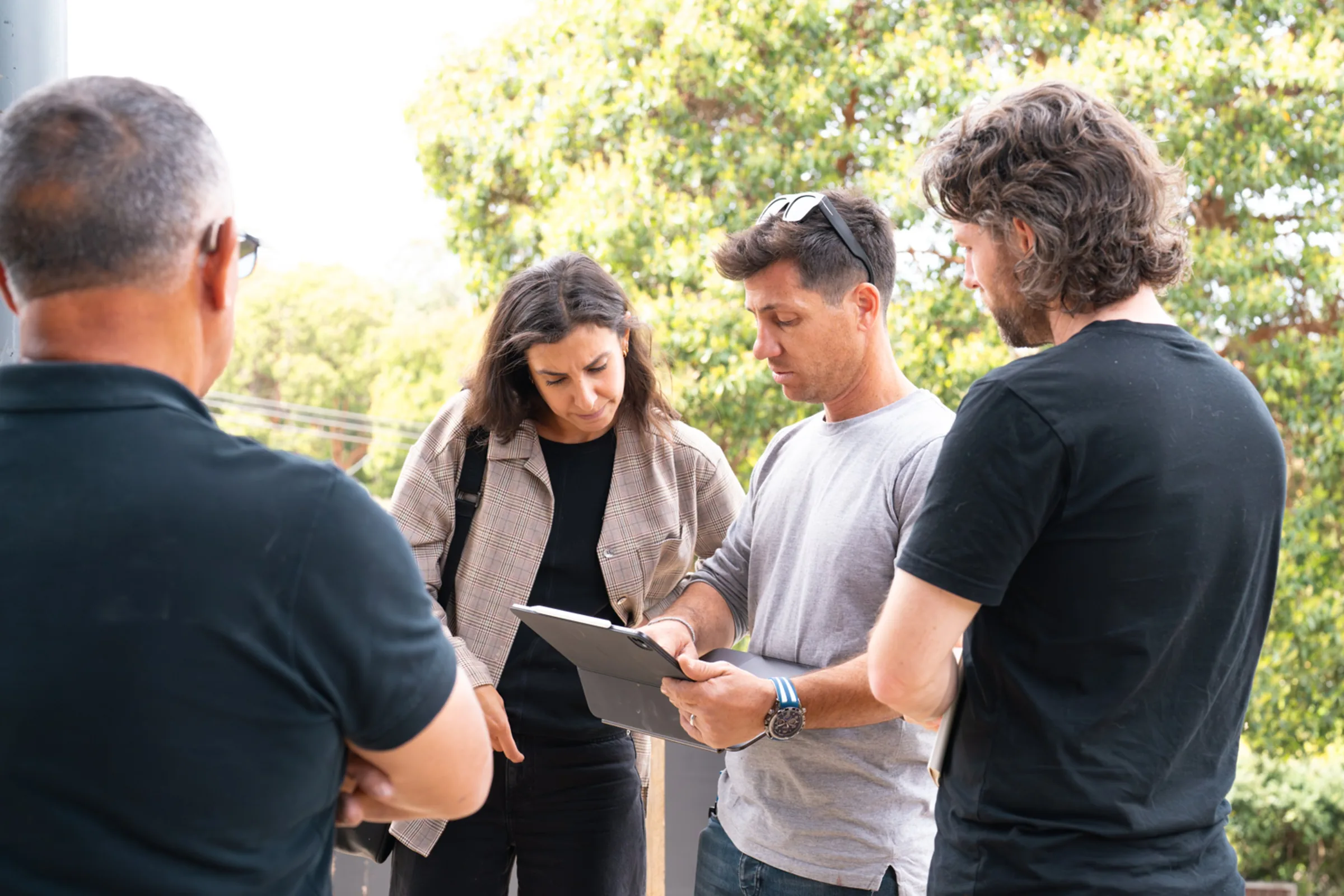 The Riviera Built team reviewing drawings together outside a build