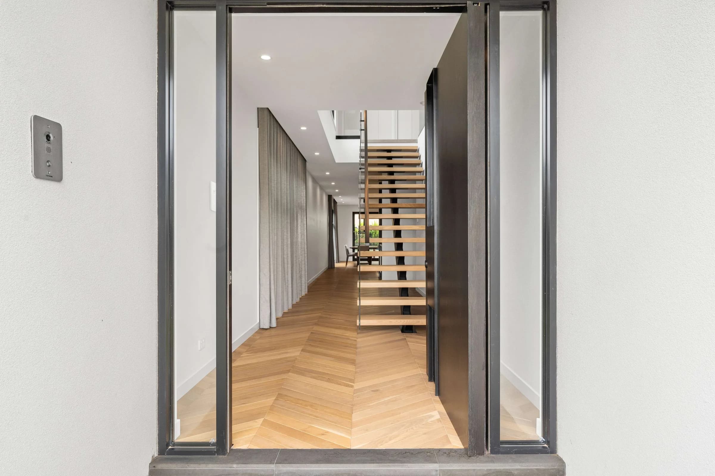 Timber stair and hallway seen through the front door