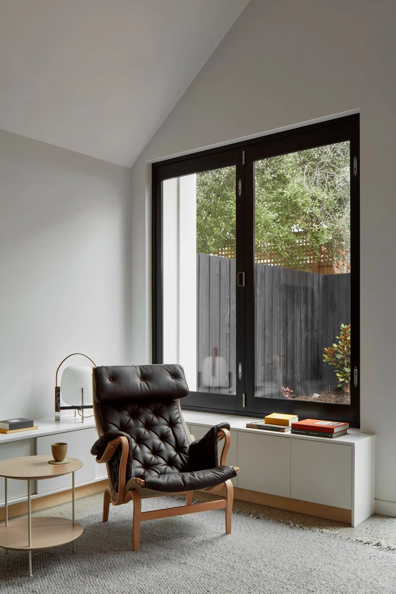 Reading corner with leather armchair by a garden window